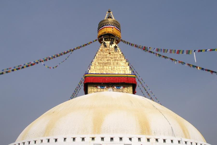 Prayer flags strung from the gilded spire of Boudhanath stupa, Kathmandu
